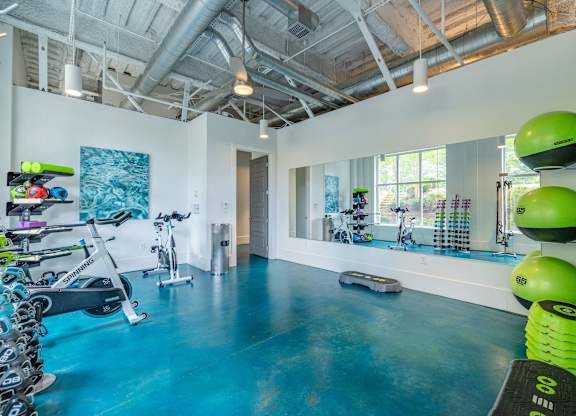 A room with exercise equipment and a blue floor at 1701 North Apartment Homes Apartments, Chapel Hill, NC