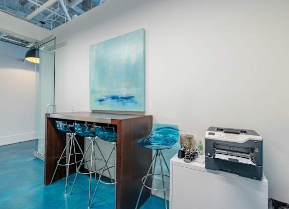 A room with a bar and a painting on the wall at 1701 North Apartment Homes Apartments, Chapel Hill