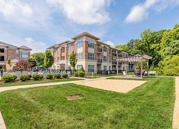 A large building with a grassy area in front of it at 1701 North Apartment Homes Apartments, North Carolina