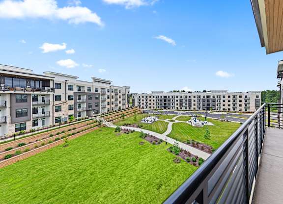 View of green lawn from a balcony at Views at Flowers, North Carolina, 27527