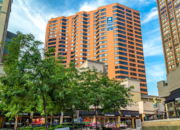 A tall orange building with a blue sign on it.