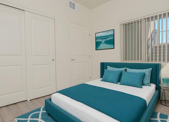 A bedroom with a bed, two doors, and a painting on the wall.