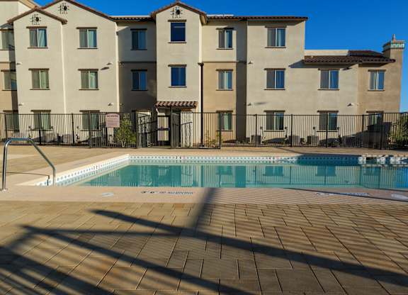 A large building with a pool in front of it.