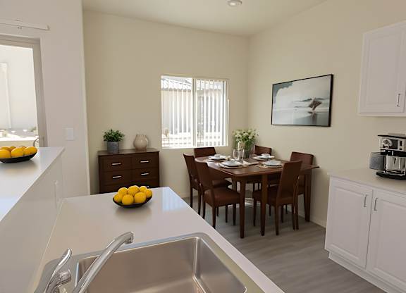 A kitchen with a dining table and chairs.