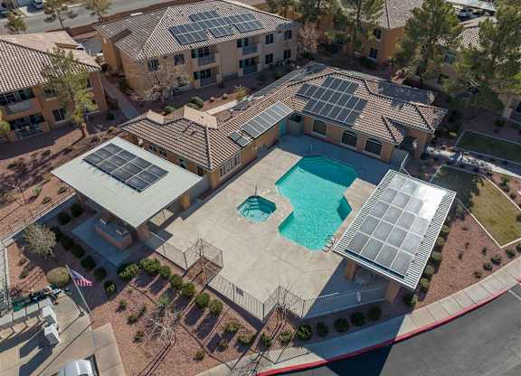 A large house with a pool and solar panels on the roof.