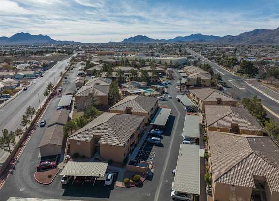 A bird's eye view of a residential area with houses and cars.