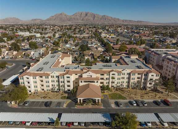 A large building with a parking lot in front of it.