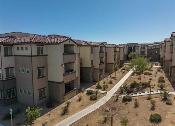 Apartment complex with brown roofs and beige walls.