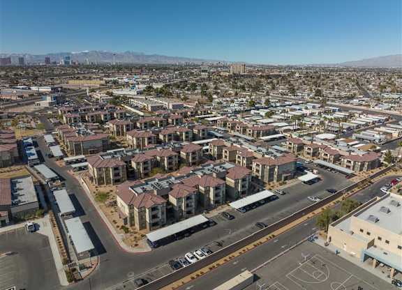 A view of a residential area with apartment buildings and a basketball court.