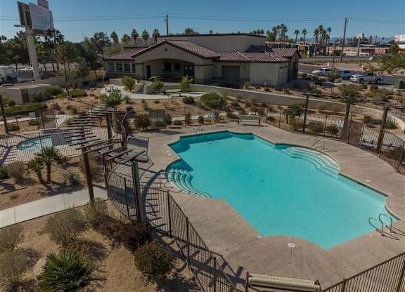 A large outdoor swimming pool surrounded by a fence.