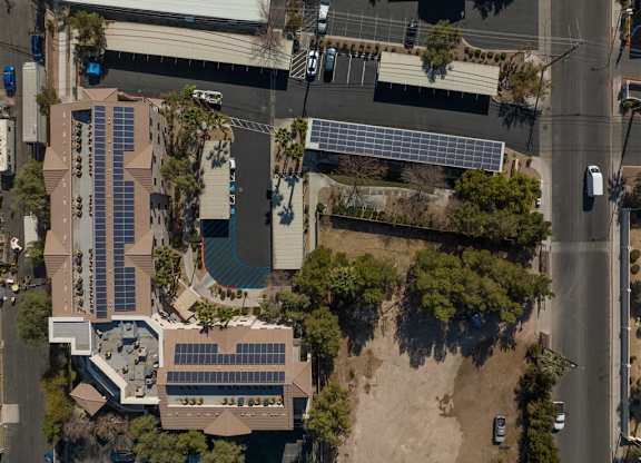 An aerial view of a building with solar panels on the roof.