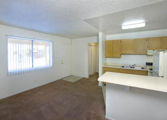 A room with brown carpet and white walls.