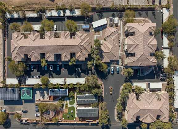 A bird's eye view of a residential area with houses and streets.