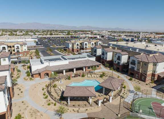 A large building complex with a pool and basketball court.