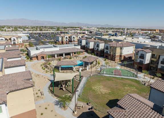 A view of a neighborhood with apartment buildings and a playground.