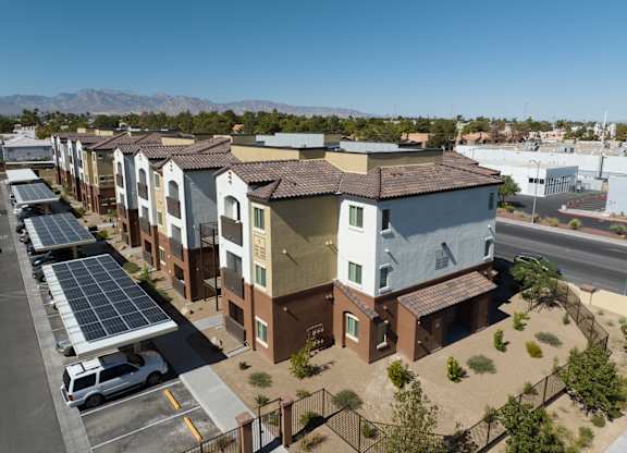 A row of houses with solar panels on the roofs.