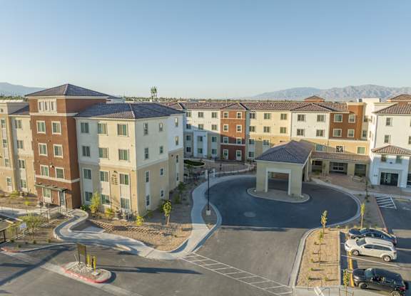 A large building complex with a circular driveway in front.