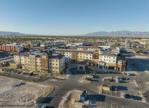 A view of a parking lot with a mountain in the background.