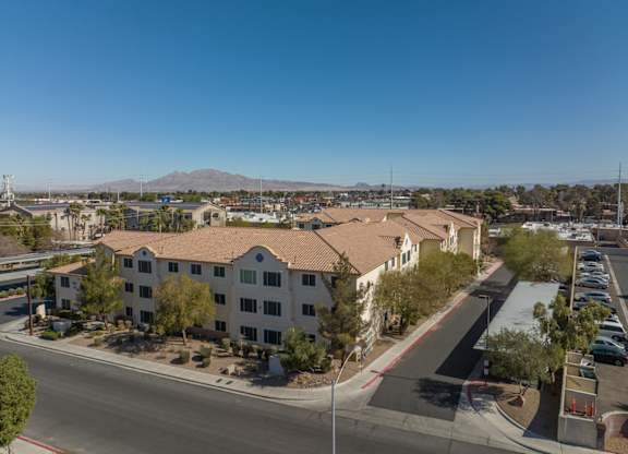 A view of a residential area with apartment buildings and a clear blue sky.