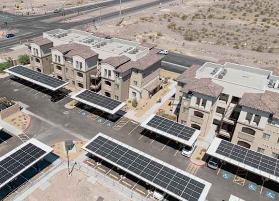 A large building with a lot of windows and solar panels on the roof.