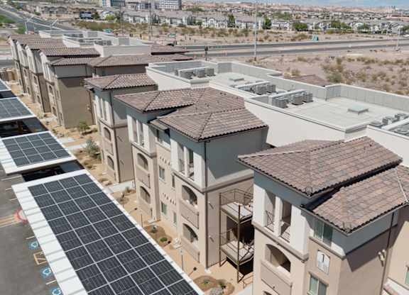 A row of houses with solar panels on the roofs.