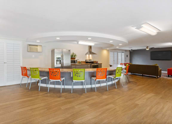 a conference room with a table and chairs and a kitchen at Terramonte Apartment Homes, Pomona, CA