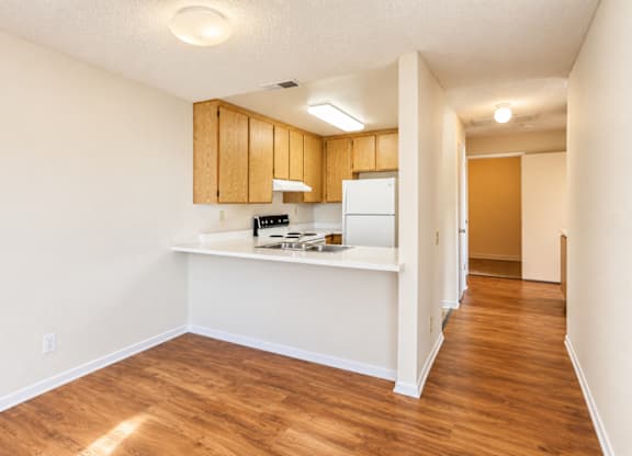 A kitchen with wooden cabinets and a white countertop.