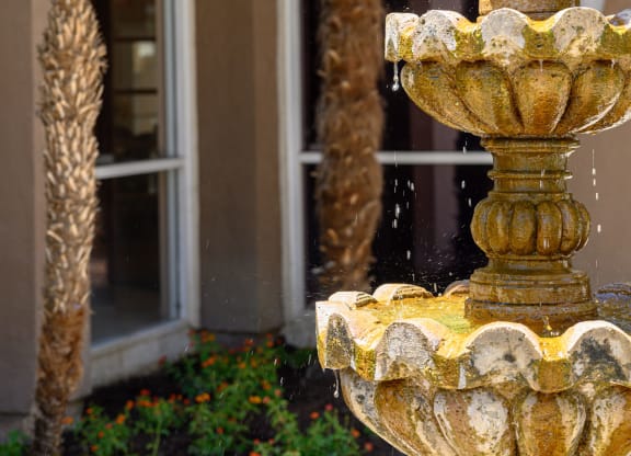 a fountain in front of a building at Oak Terrace Senior Apts, Hemet