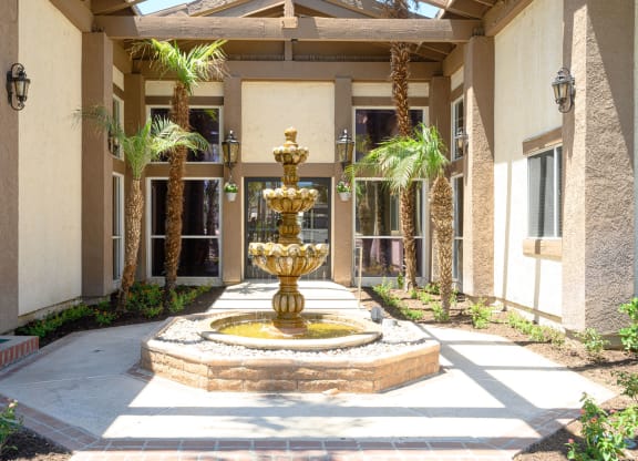 a fountain in front of a building at Oak Terrace Senior Apts, Hemet, 92543