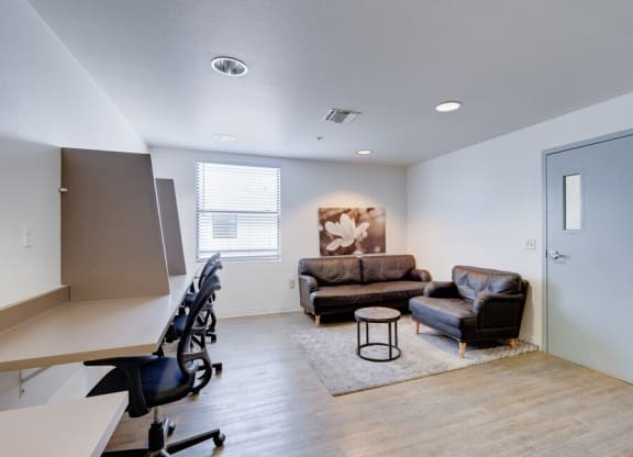 our apartments offer a living room with a couch and a coffee table at Helix at University Village, Pomona