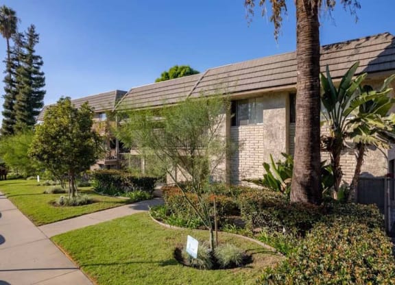 a building with a red roof and a sidewalk in front of it at Mountainview Venture, Covina, CA