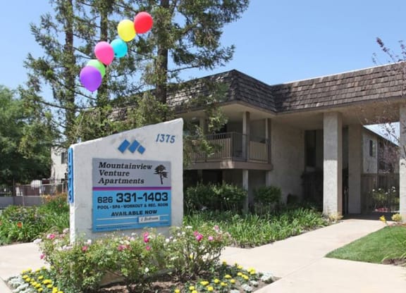 a building with a sign and balloons in front of it at Mountainview Venture, Covina, CA