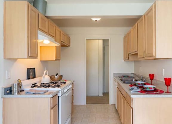 a kitchen with a stove top oven next to a sink at Mountainview Venture, Covina, CA 91722