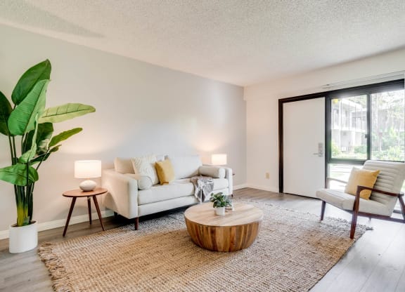 a living room with a couch and a coffee table and a sliding glass door at University Park, California, 91702