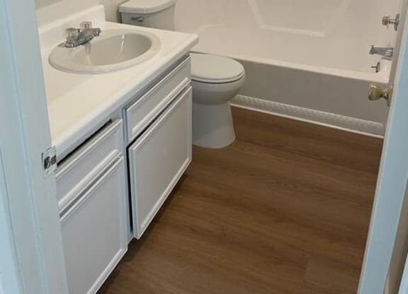 a bathroom with a toilet sink and bathtub at Fiesta Apts, Lompoc, CA