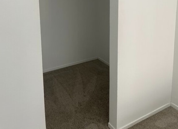 a walk in closet in a bedroom at Fiesta Apts, California