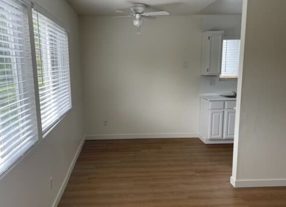 an empty living room with a ceiling fanat Fiesta Apts, Lompoc, CA