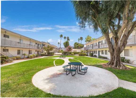 a park with a picnic table and a tree in a courtyard at Sunnymead Apts Apartments, California, 92553