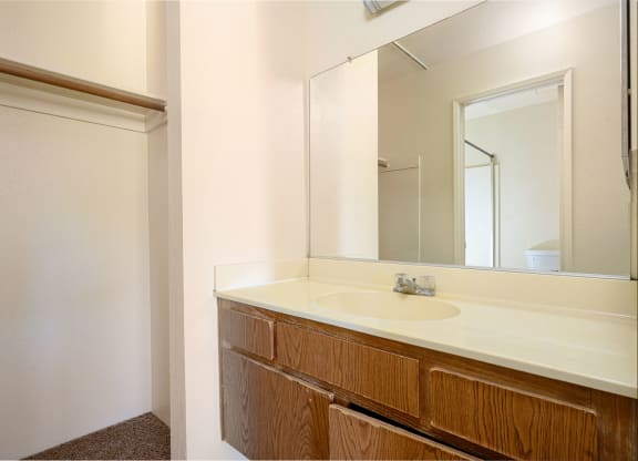 a bathroom with a sink and a mirror at Park Columbia Apts, Hemet