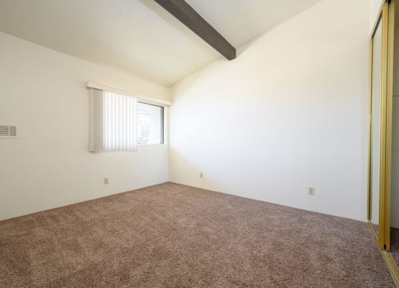 a bedroom with white walls and carpet at Park Columbia Apts, Hemet, 92544
