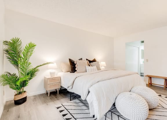 a bedroom with a bed and a potted plant at Alosta Place, Azusa, CA