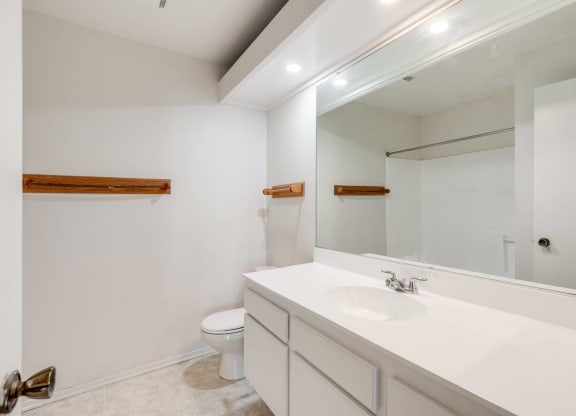 a bathroom with a large mirror and a sink and a toilet at Alosta Place, Azusa, 91702