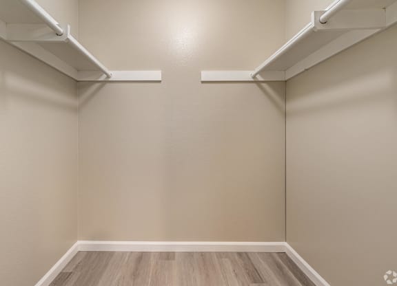 an empty room with white shelves on the wall and wood floors at Colima Terrace Apts, Rowland Heights, CA 91748