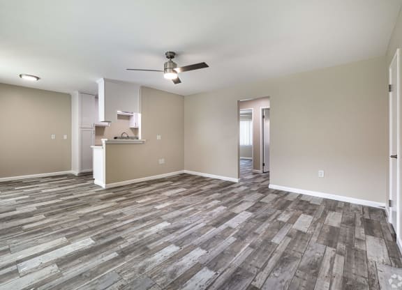 an empty living room with vinyl flooring and a ceiling fan at Colima Terrace Apts, Rowland Heights California
