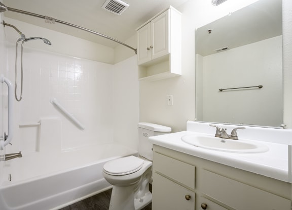 a bathroom with a bathtub toilet sink and mirror at Sagewood Gardens Senior Apartments, California, 91745