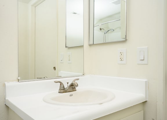 a bathroom with a sink and a mirror at Sagewood Gardens Senior Apartments, Hacienda Heights, 91745