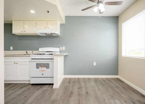a kitchen with a stove and a ceiling fan at Sagewood Gardens Senior Apartments, Hacienda Heights