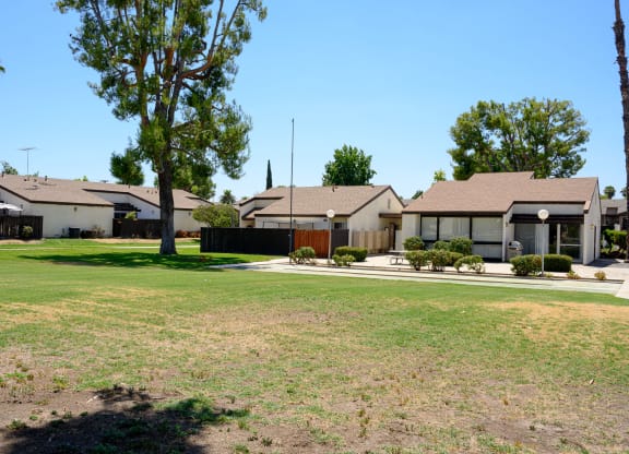 a row of houses with a large yard in the foreground at Villa Hemet, Hemet California
