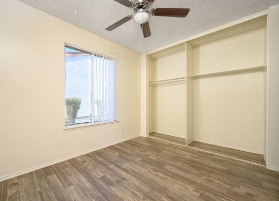 a bedroom with a large window and a ceiling fan at Villa Hemet, California