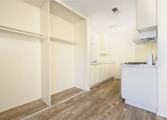 a kitchen with white walls and wood flooring at Villa Hemet, California